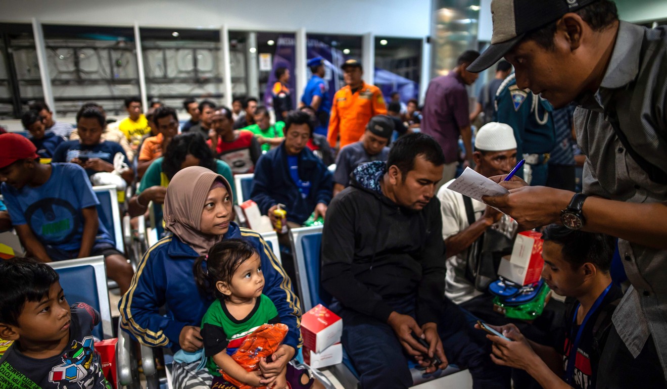 Ferry passengers gather at Tangjung Perak seaport in Surabaya, East Java, on Friday after being evacuated. Photo: AFP
