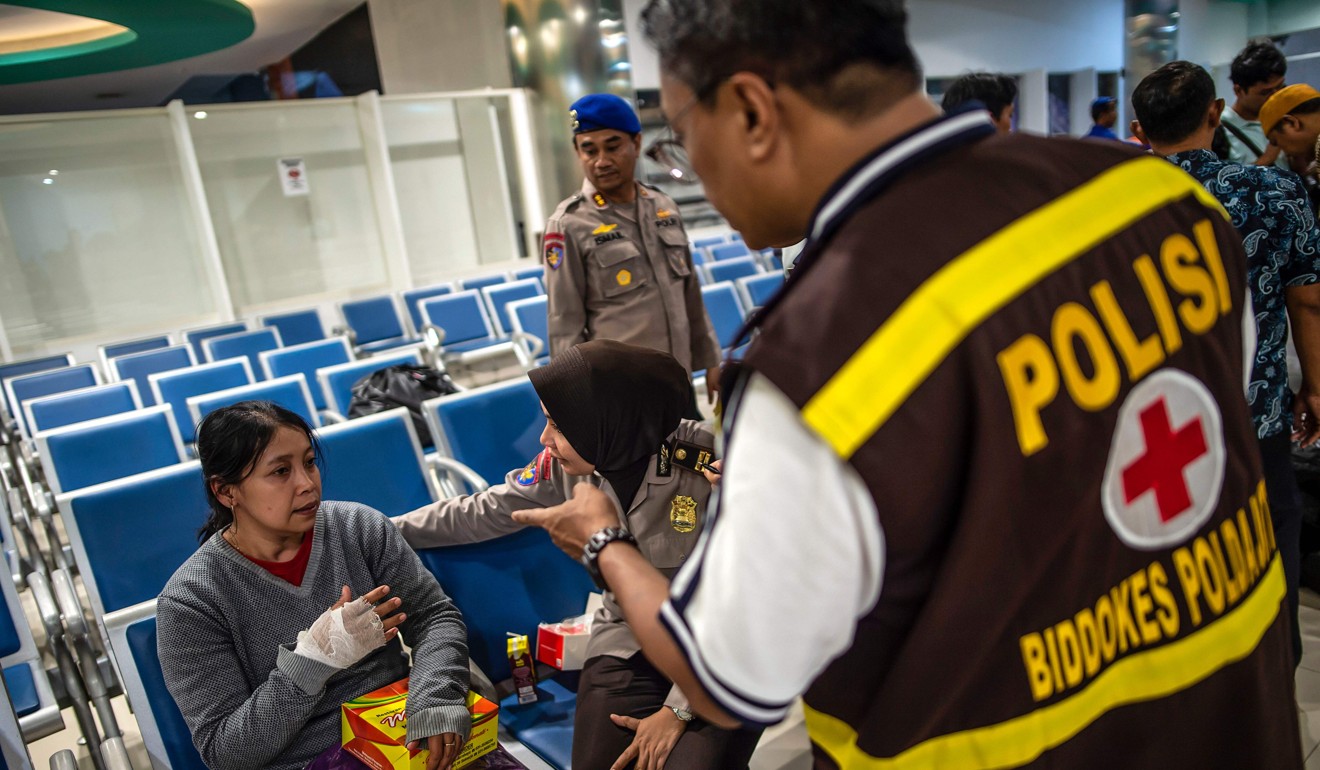 A ferry passenger gets medical treatment at Tangjung Perak seaport in Surabaya, East Java, on Friday. Photo: AFP