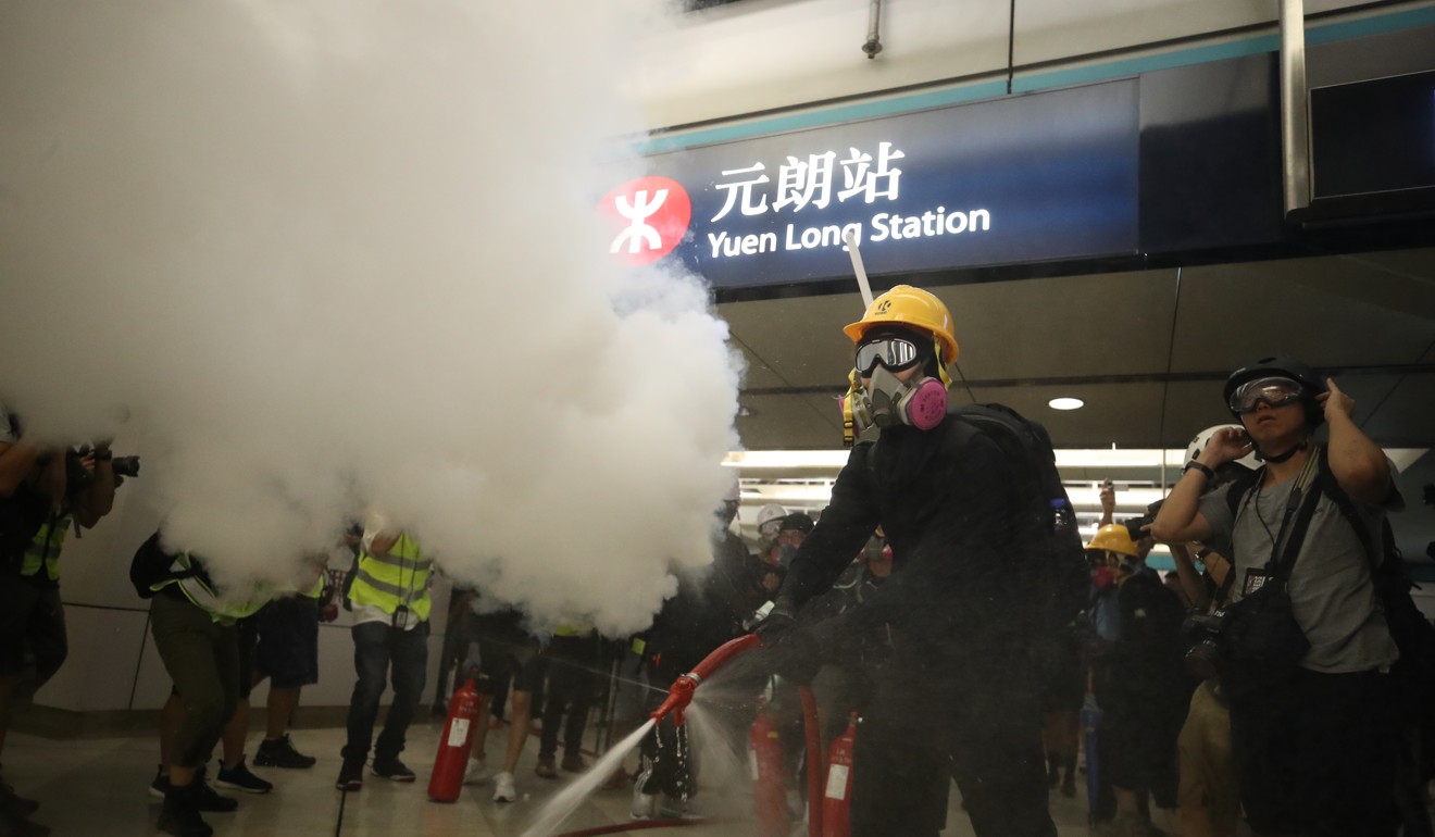Protesters used fire extinguishers and a fire hose against riot police at Yuen Long MTR Station to mark a month since a violent clash in the station. Photo: Winson Wong