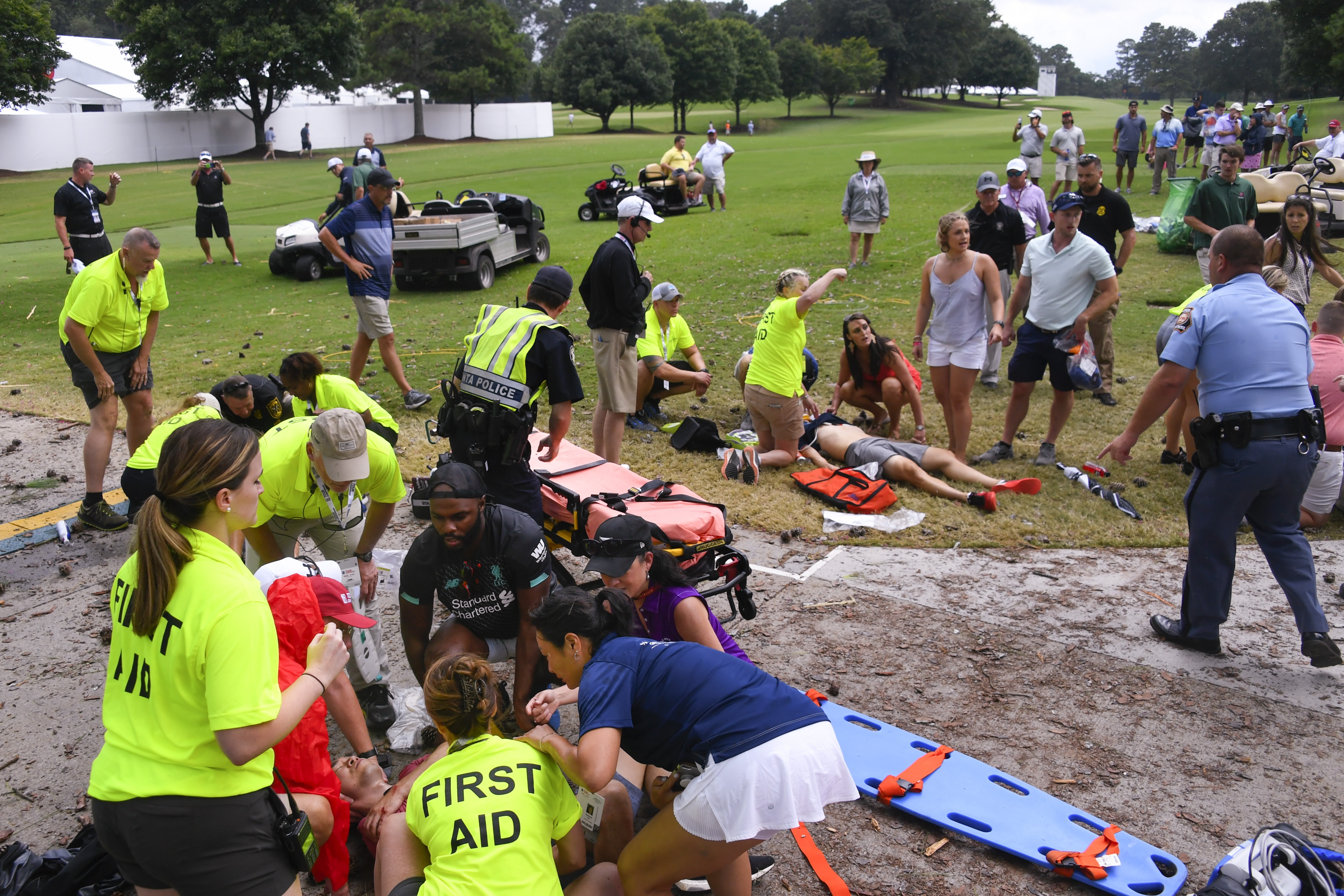 Spectators are tended to after a lightning strike on the East Lake Golf Club course. Photo: AP Photo