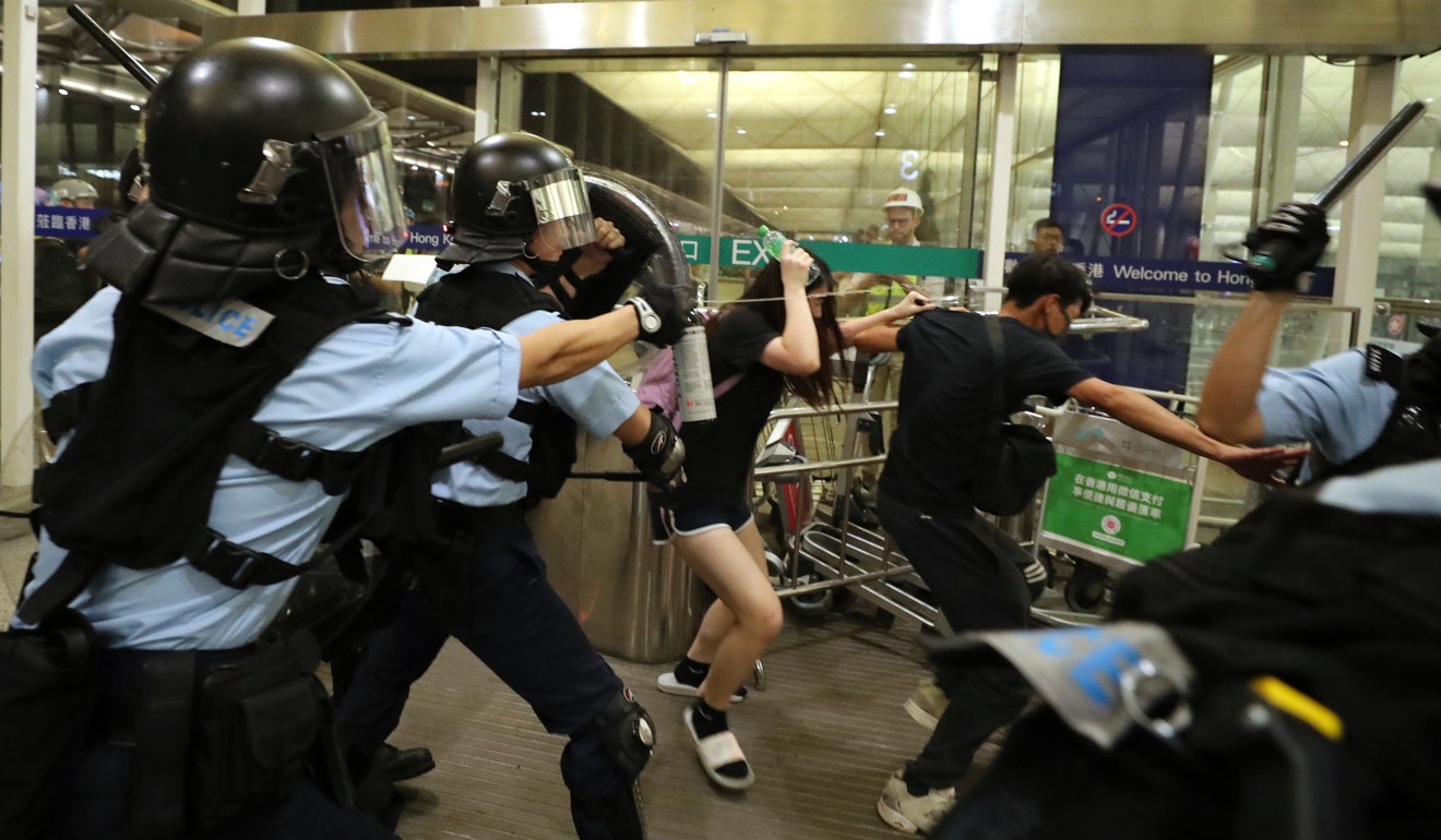 Riot police deploy pepper spray during a clash with protesters at Hong Kong International Airport on August 13. Photo: Sam Tsang