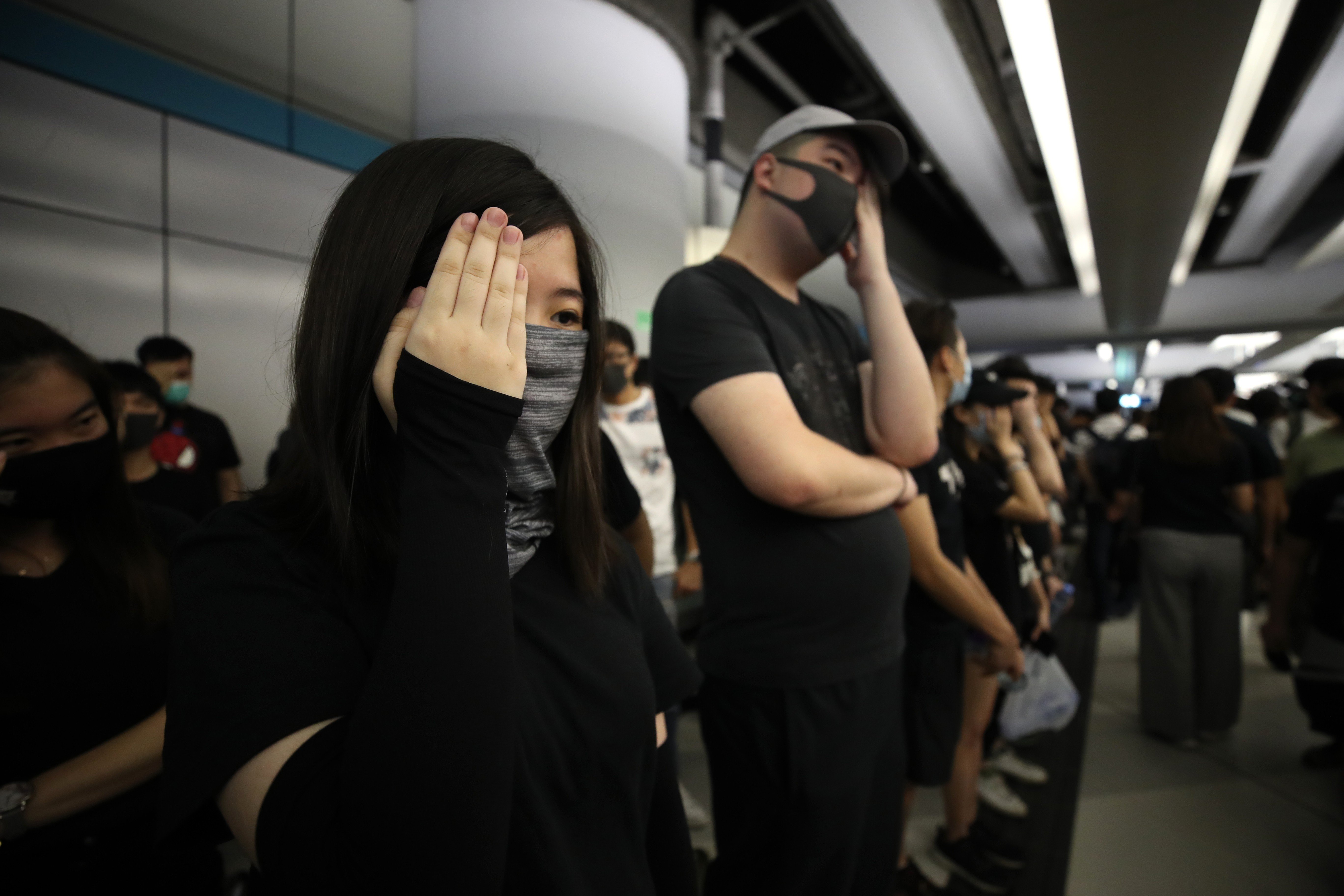 Protesters stage a sit-in on August 21 wearing their trademark all-black outfits. Photo: Winson Wong