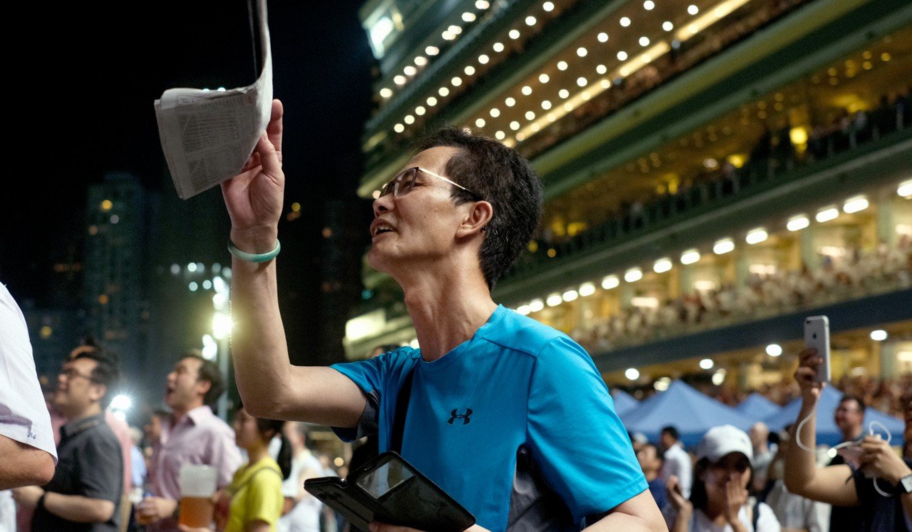 A punter cheers home his horse at Happy Valley. Photo: SCMP