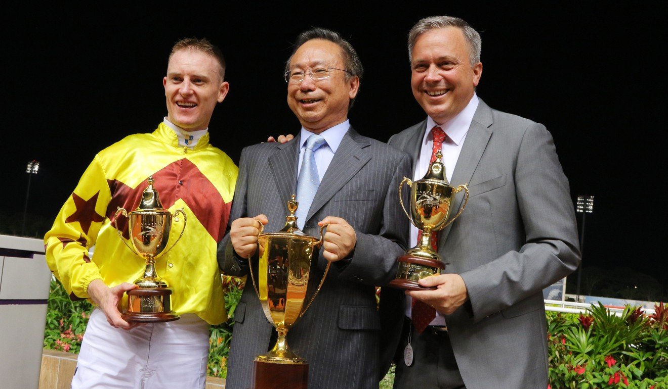 Jockey Zac Purton celebrates the win of Southern Legend with owner Boniface Ho in Singapore.