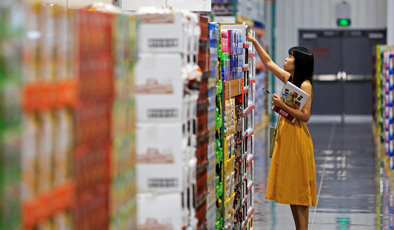 A staff member checks stocks ahead of the store’s opening. Photo: AFP