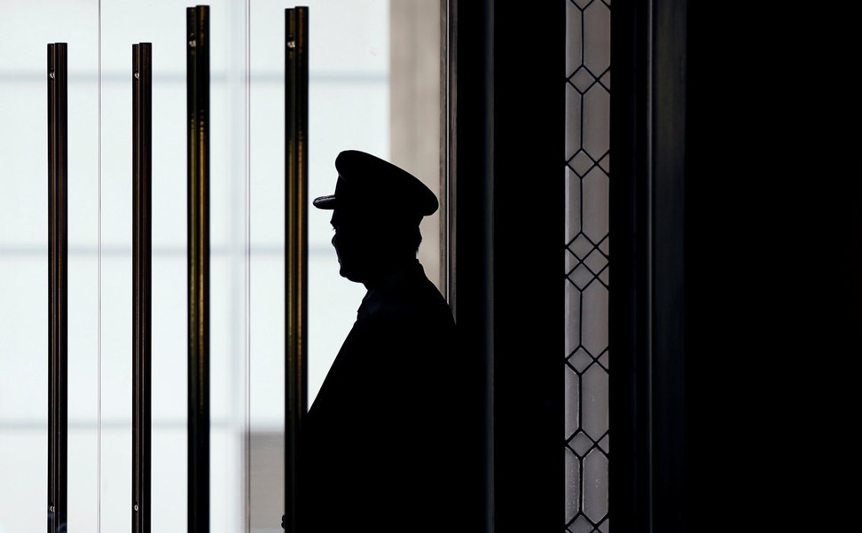 A doorman at the entrance of the Trump International Hotel Washington, DC. Photo: Reuters