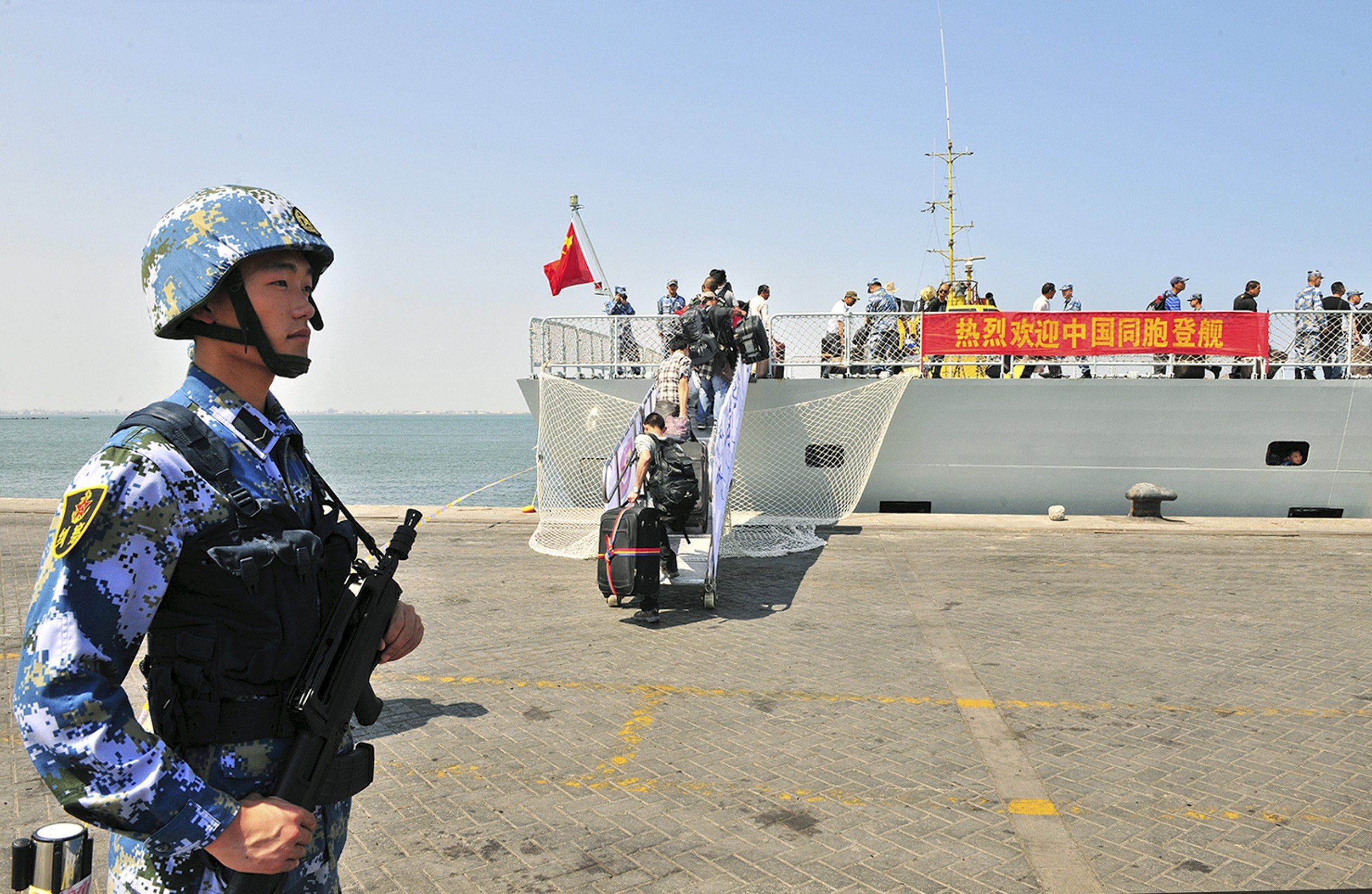 A soldier of the People’s Liberation Army stands guard as Chinese citizens board a navy ship in Aden in 2015. Photo: Reuters
