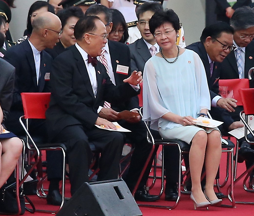 Former Hong Kong chief executive Donald Tsang speaks to then chief secretary Carrie Lam during a flag-raising ceremony to celebrate the 66th anniversary of the founding of the People’s Republic of China, at the Golden Bauhinia Square in Wan Chai on October 1, 2015. Photo: K.Y. Cheng