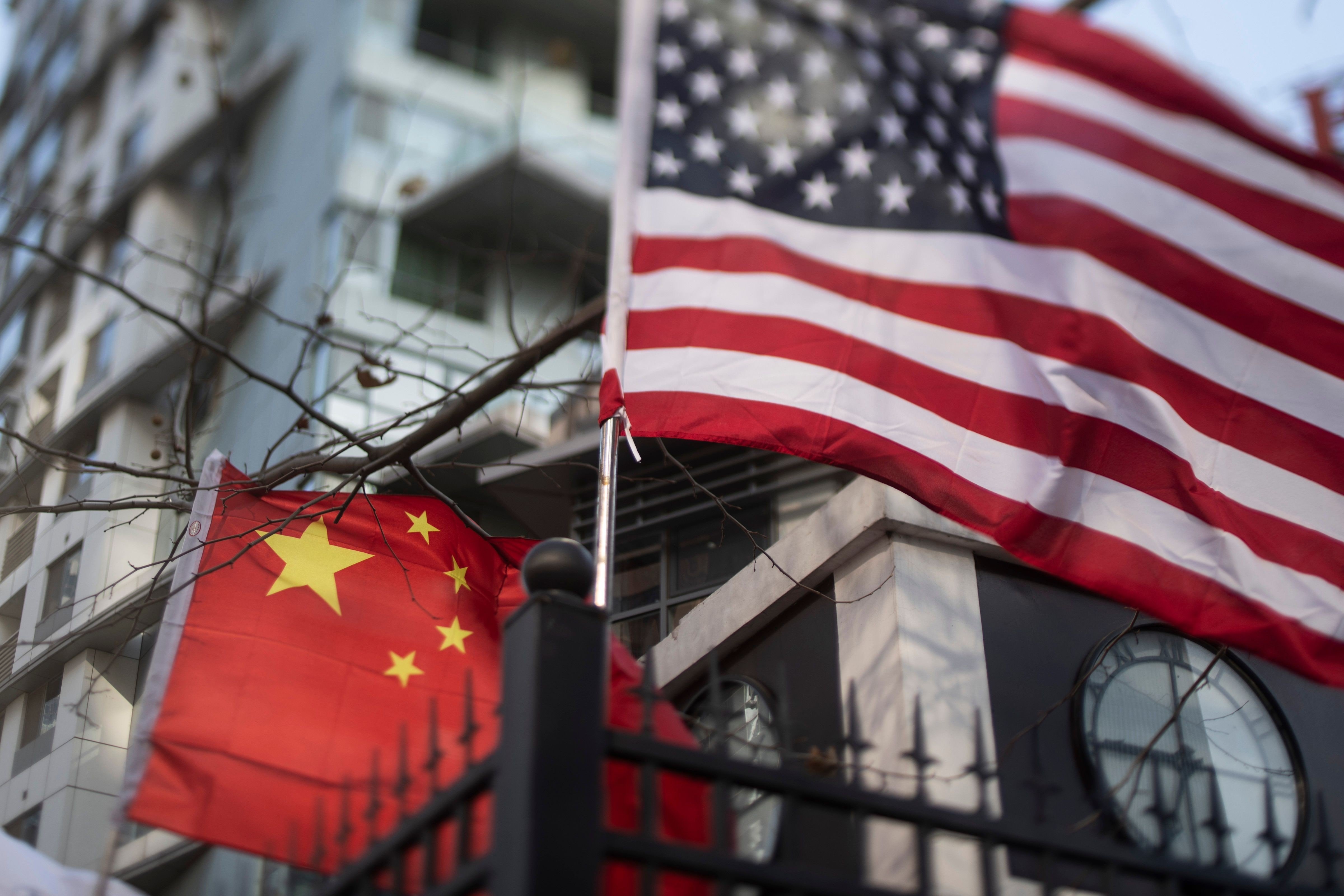 Chinese and US national flags at an international school in Beijing. US-China trade friction is hurting the outlook for American companies operating in China, according to the US-China Business Council member survey. Photo: AFP