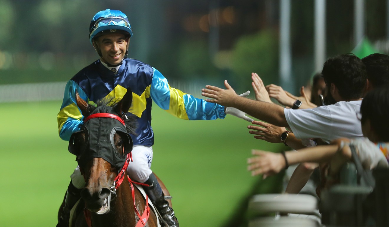 Joao Moreira high-fives fans at Happy Valley.