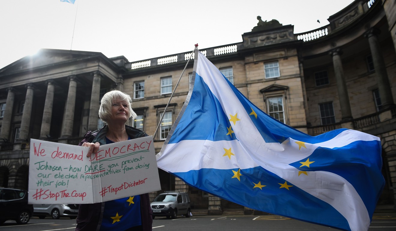 A protester demonstrates against Boris Johnson's decision to suspend parliament outside the Court Of Session in Edinburgh, Scotland. Photo: AFP