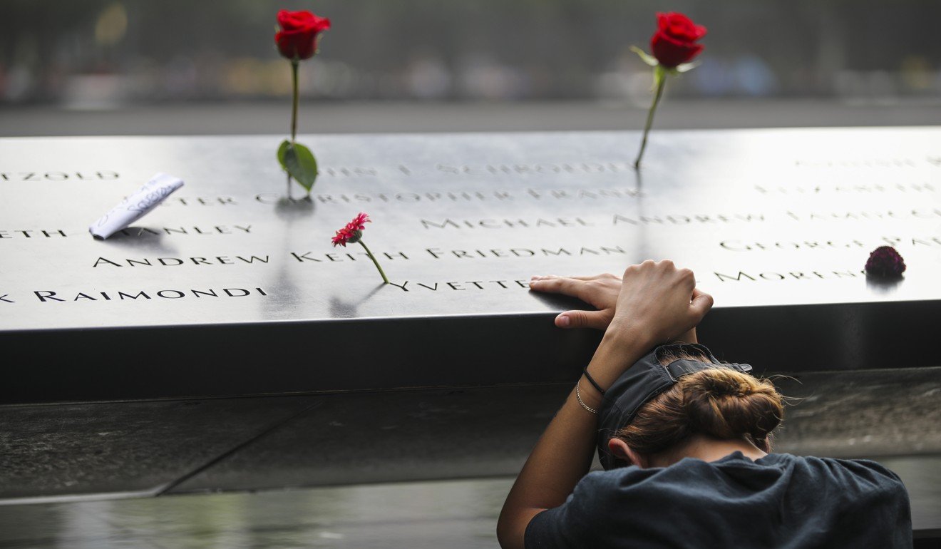 A woman pauses beside a memorial in New York on which the names of 9/11 victims are inscribed. Photo: Xinhua