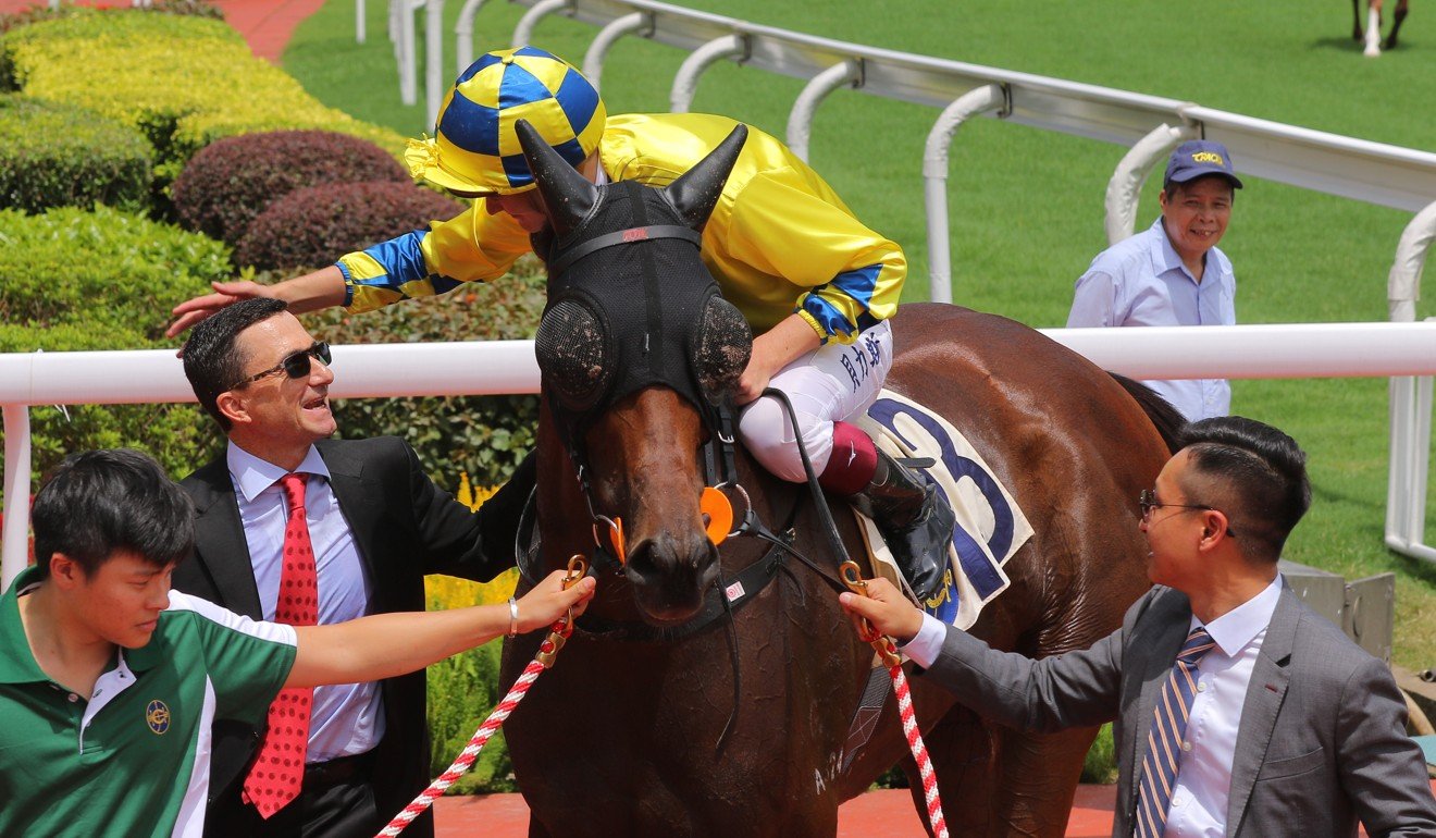 Trainer Douglas Whyte and jockey Regan Bayliss celebrate the win of Adonis at Sha Tin on Sunday.