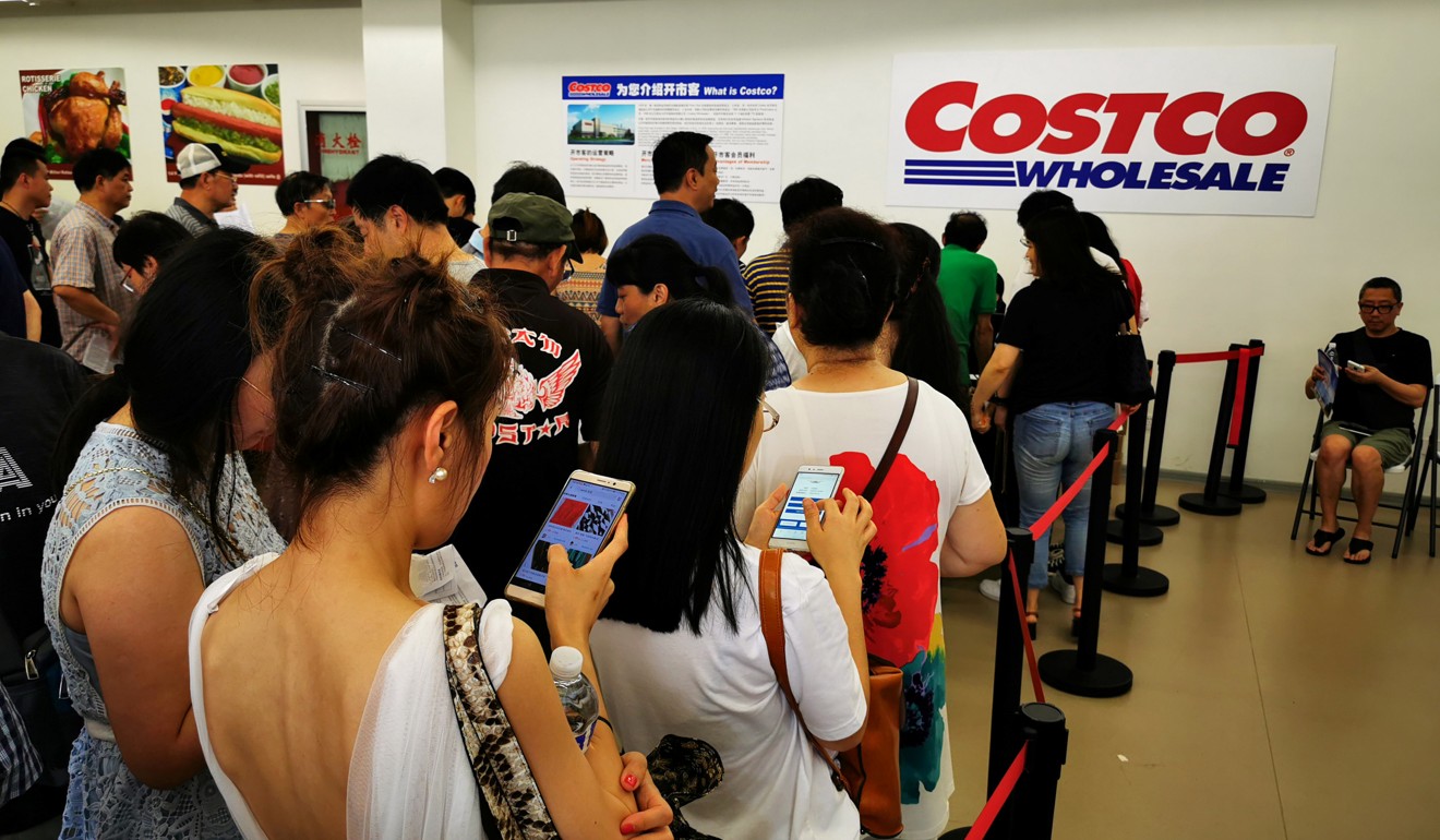 People queue to sign up for membership of US retail giant Costco, which opened its first store in China last week. Photo: Reuters