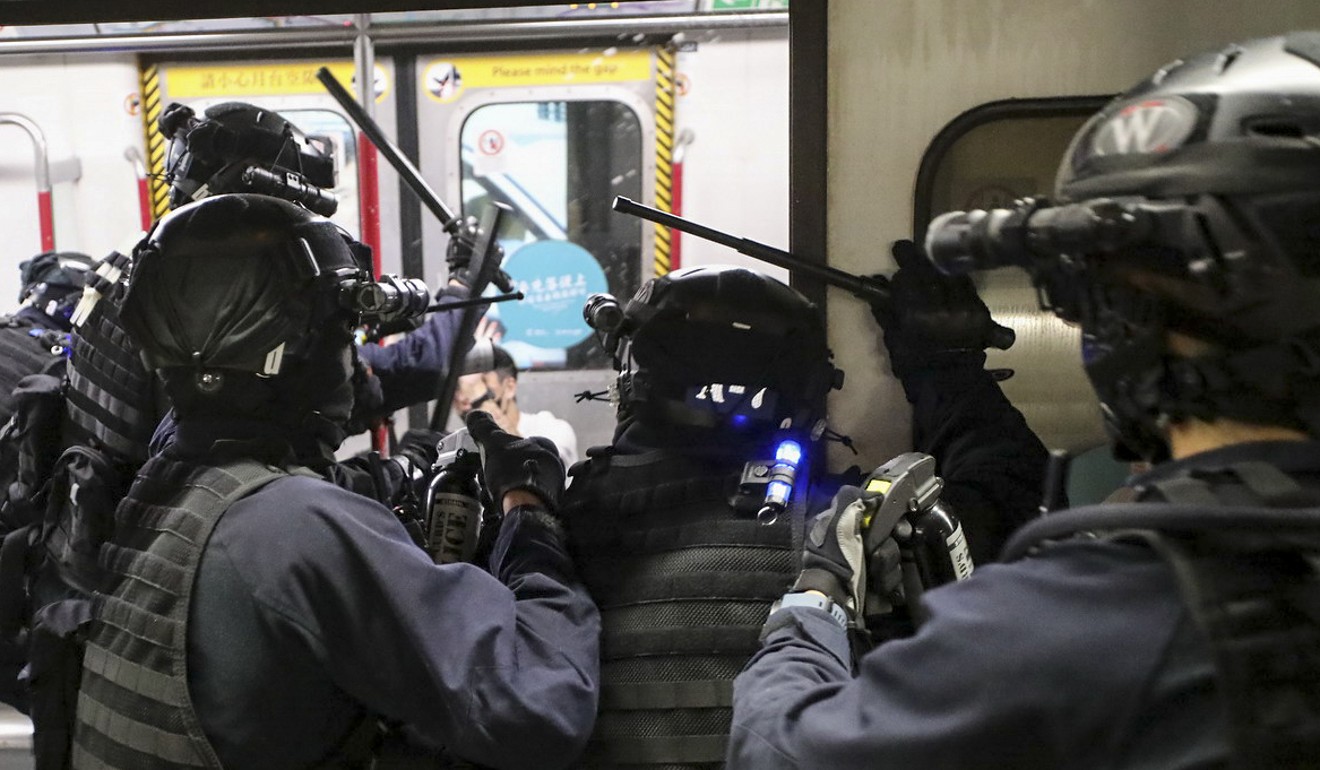Riot police storm onto an MTR train in Prince Edward station. Photo: Handout