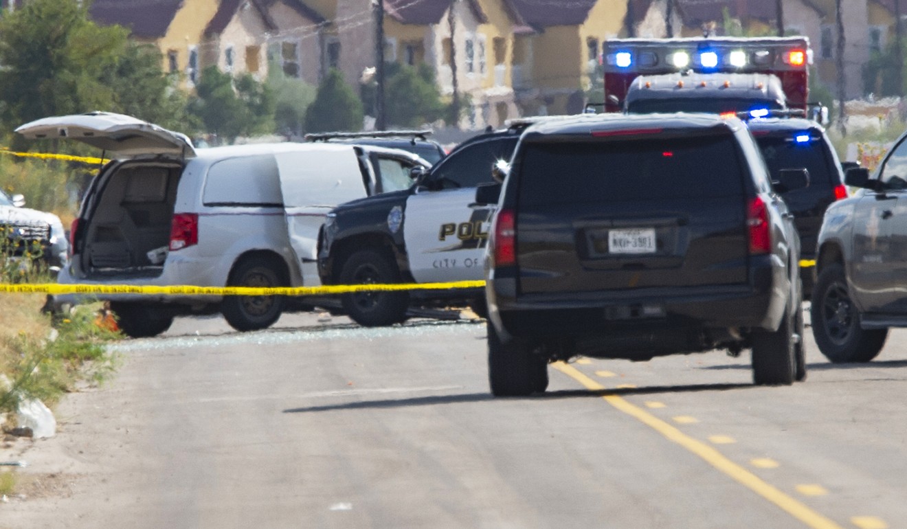 Police vehicles surround a white van in Odessa, Texas. Photo: AP