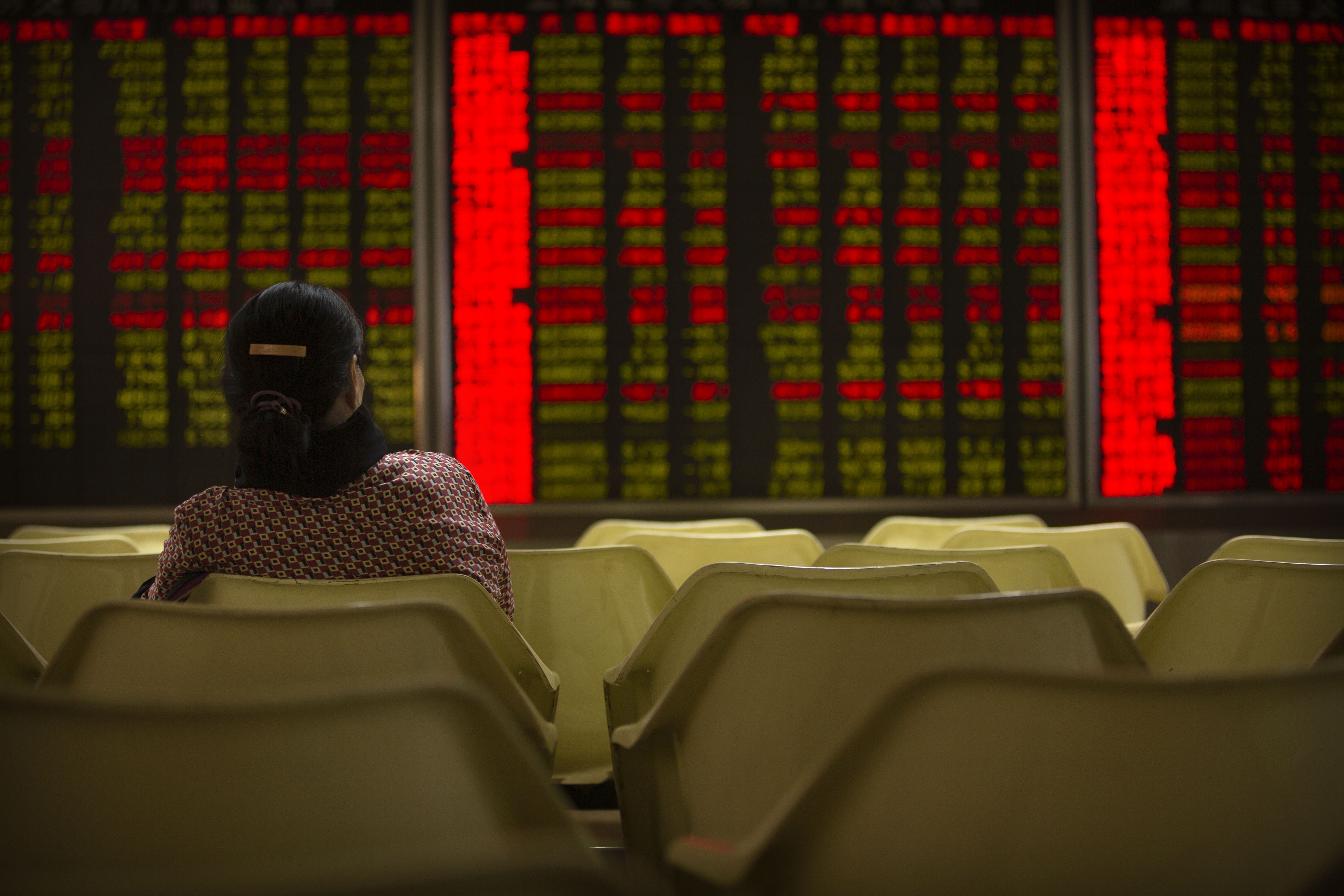 A Chinese investor monitors stock prices at a brokerage house in Beijing on August 30. Photo: Associated Press