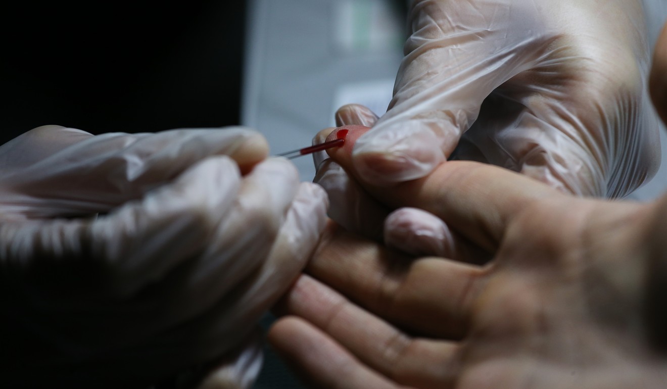 A finger is pricked at the Aids Concern Centre, Jordan, to give blood for an HIV rapid test, which gives a result in 20 minutes. Photo: Dickson Lee