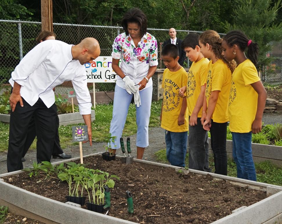 Former US first lady Michelle Obama (centre left) plants vegetables with children at Bancroft Elementary School in Washington in 2009. Obama was committed to trying to get kids to eat more healthily. Photo: AFP