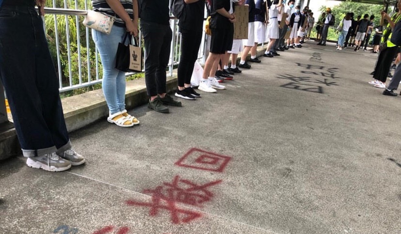 Students and alumni from four secondary schools in Tuen Mun form a human chain on Thursday morning. Photo: Handout