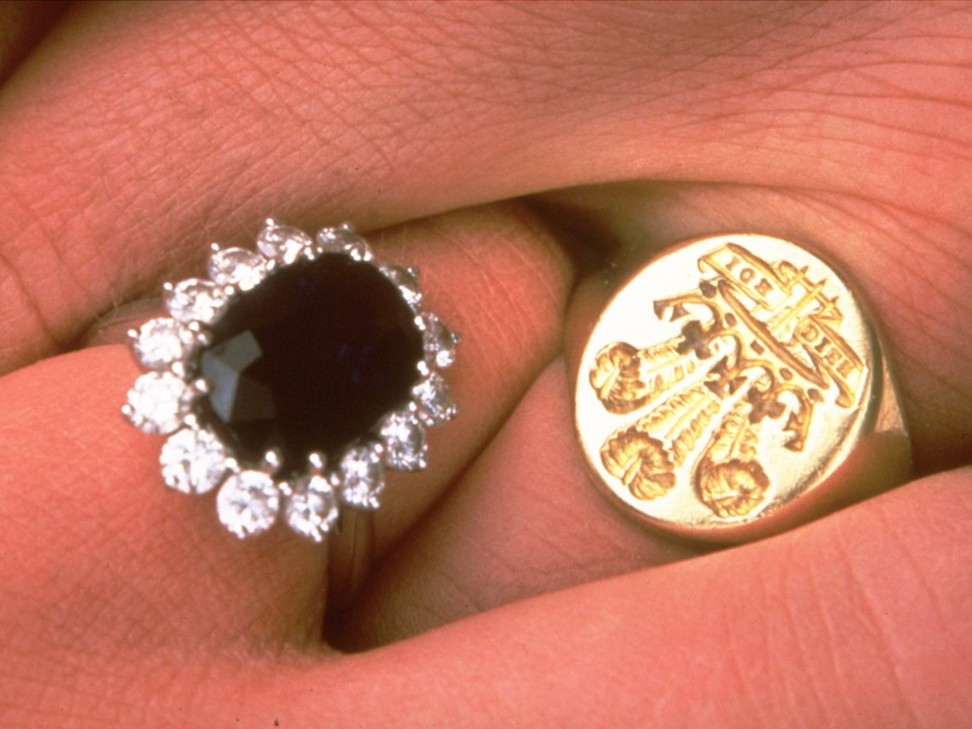 Diana Spencer’s sapphire and diamond engagement ring, pictured beside Prince Charles’ ring, featuring his official Prince of Wales crest, at the time of their official engagement in February 1981