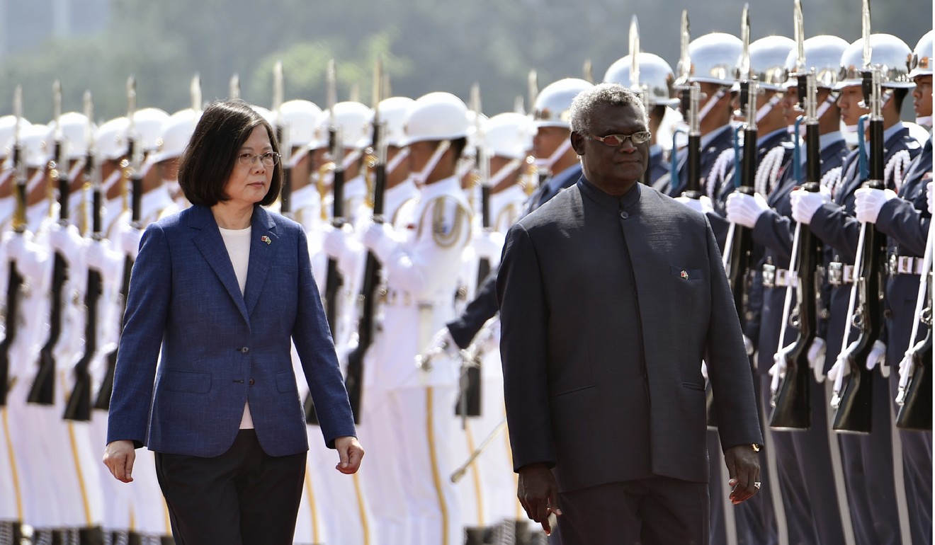 Solomon Islands President Manasseh Sogavare and Taiwan President Tsai Ing-wen inspect an honour guard in Taipei in 2017. Photo: AFP