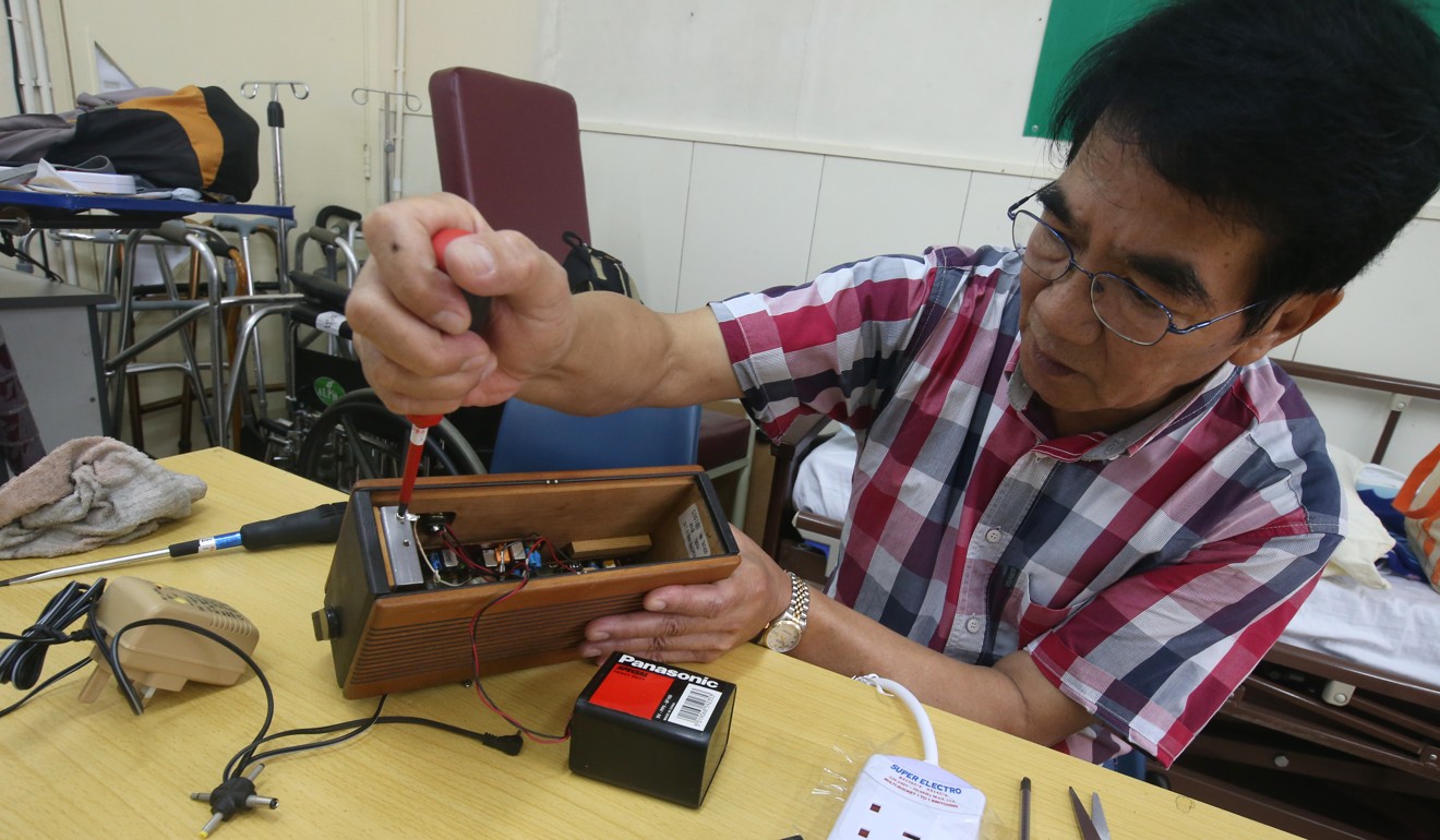 Siu repairs a radio at the Repair Cafe. Photo: David Wong