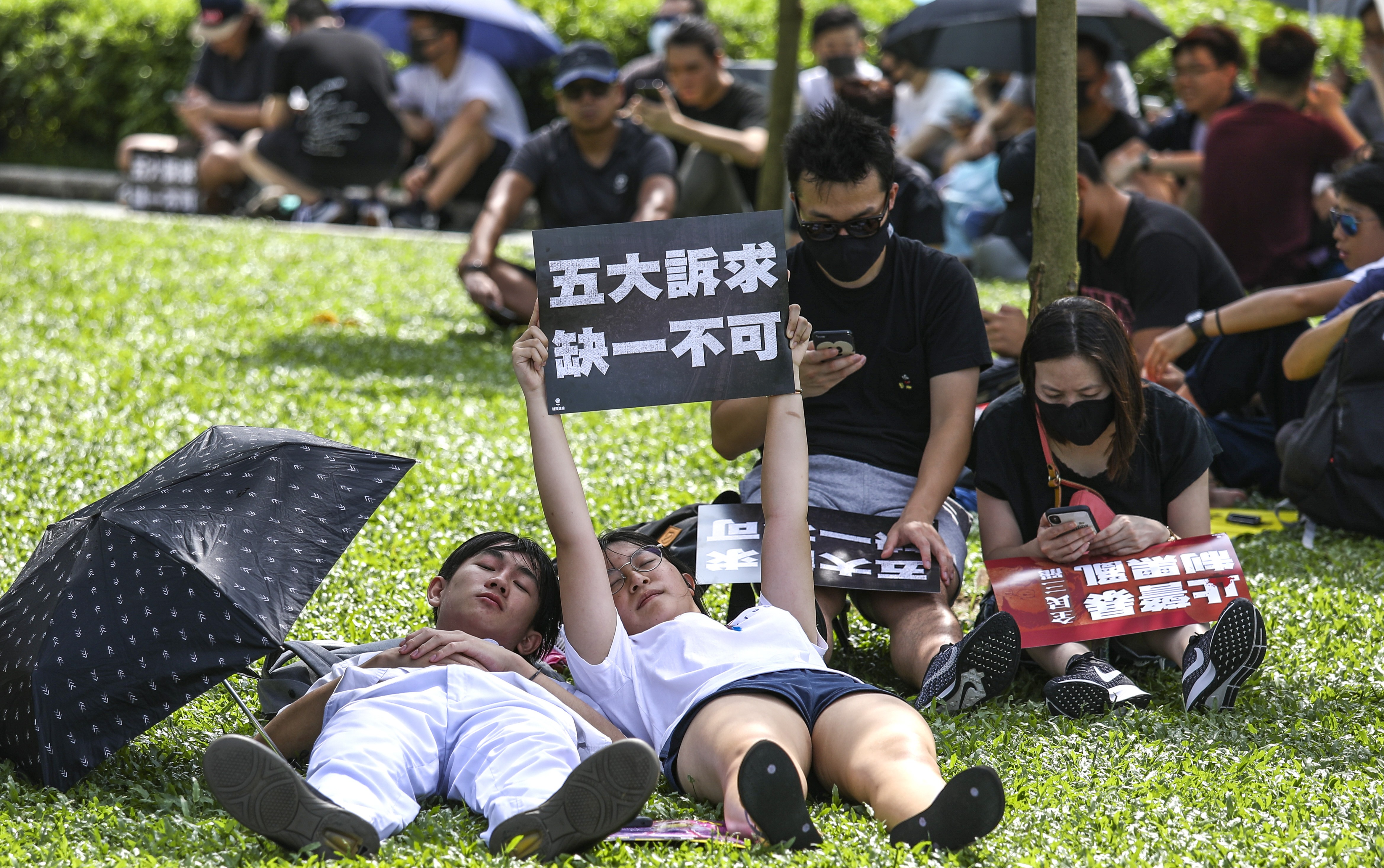 Protesters sneak a nap during a rally to support striking students at Tamar Park on Tuesday. Photo: Tory Ho