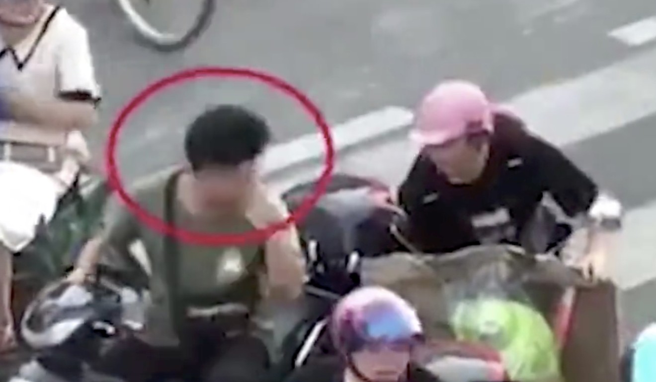 Who me? A scooter rider reacts as he is told to put on his helmet at an intersection in Putian, Fujian province, in footage apparently filmed by a passer-by. Photo: Weibo