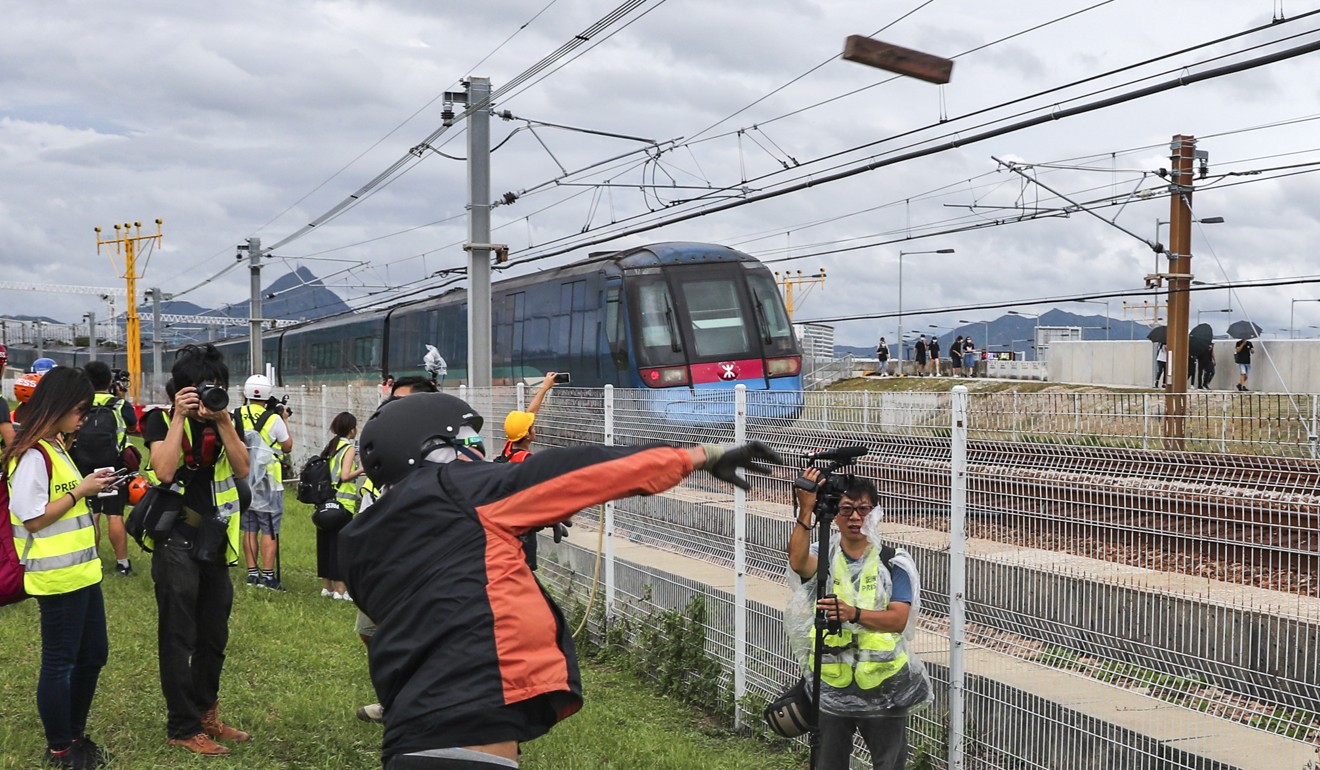 Protesters bring an Airport Express train to halt by throwing objects onto the track on September 1. Photo: Sam Tsang