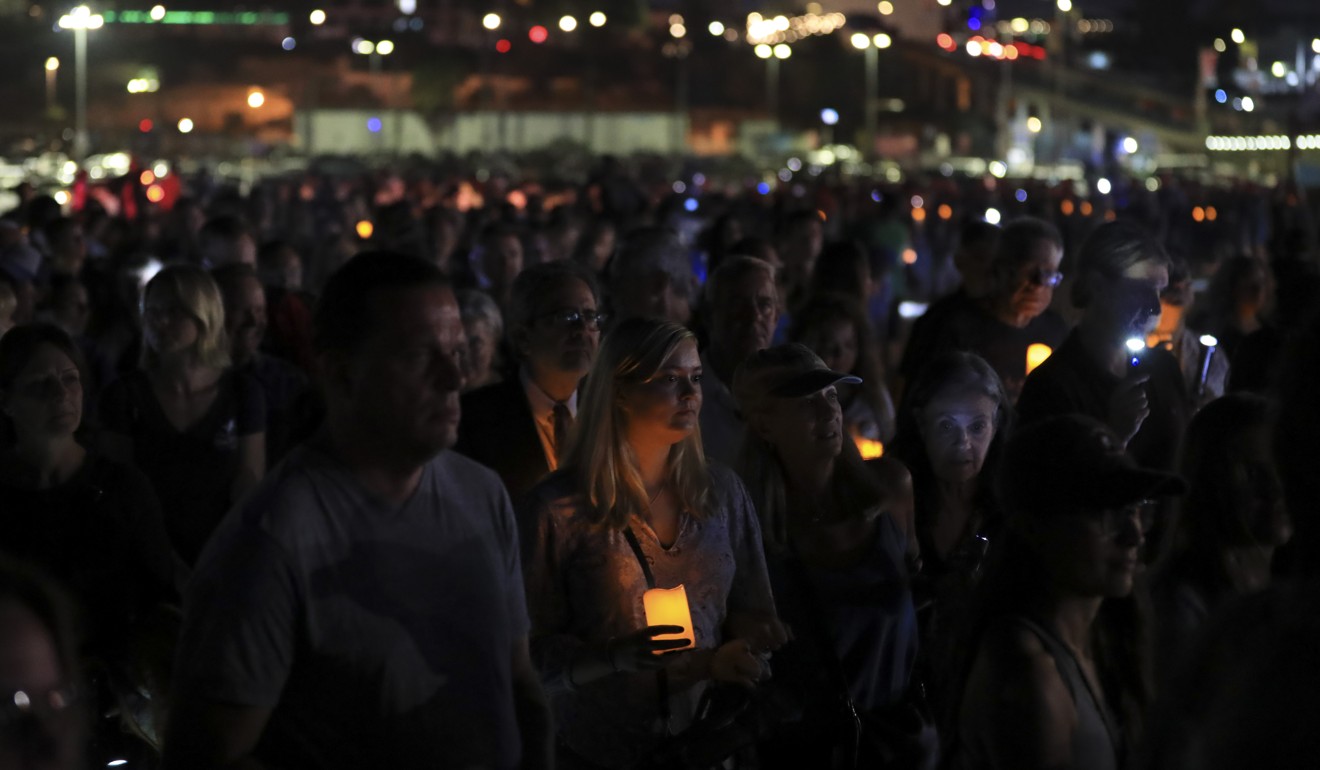 People take part in a prayer and vigil for victims of the fire on Thursday. Photo: XInhua