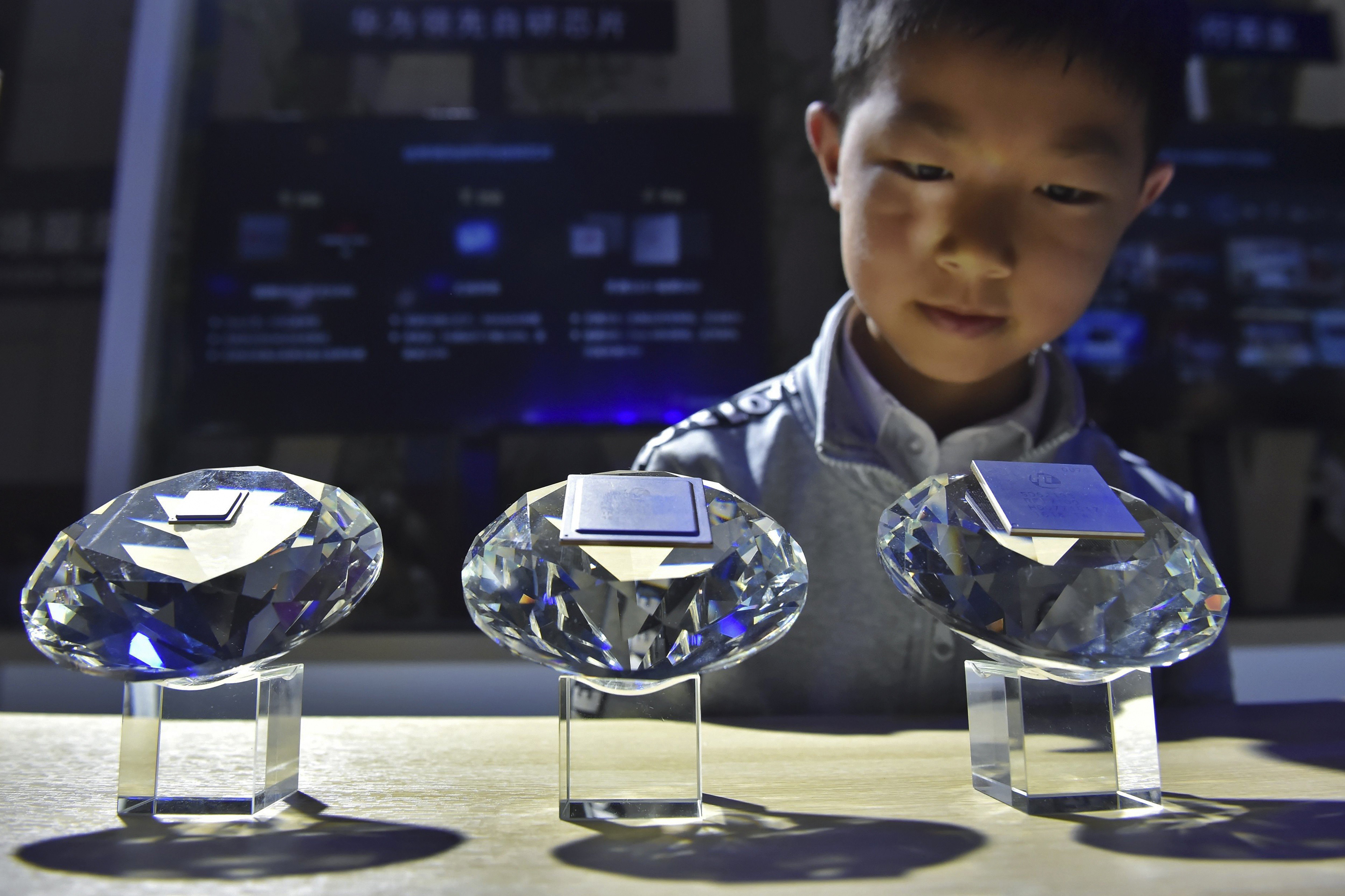 A child looks at HiSilicon chips designed for Huawei Technologies’ 5G base stations on display at the China International Big Data Industry Expo held in May in Guiyang, capital of southwest China's Guizhou province. Photo: Xinhua