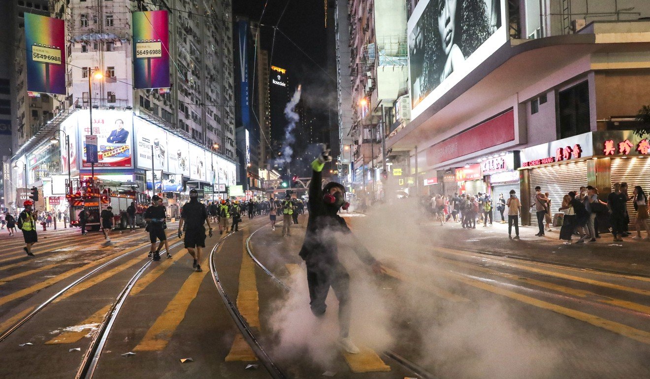 Riot police fire tear gas on Hennessy Road in Causeway Bay. Photo: Sam Tsang