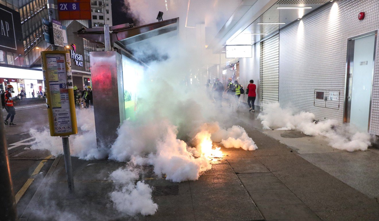 By night, the familiar smoky scenes of Hong Kong streets choking on tear gas returned. Photo: Sam Tsang
