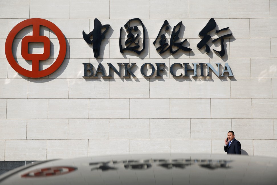 A man speaks on the phone outside the Bank of China head office building in Beijing. Photo: Reuters
