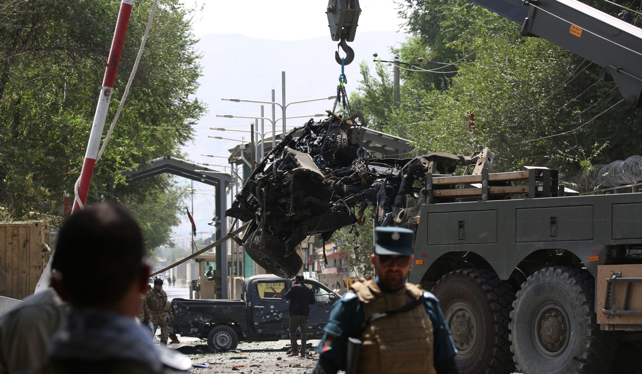 A vehicle is removed from the site of a car-bomb attack in Kabul on Thursday. Photo: Xinhua