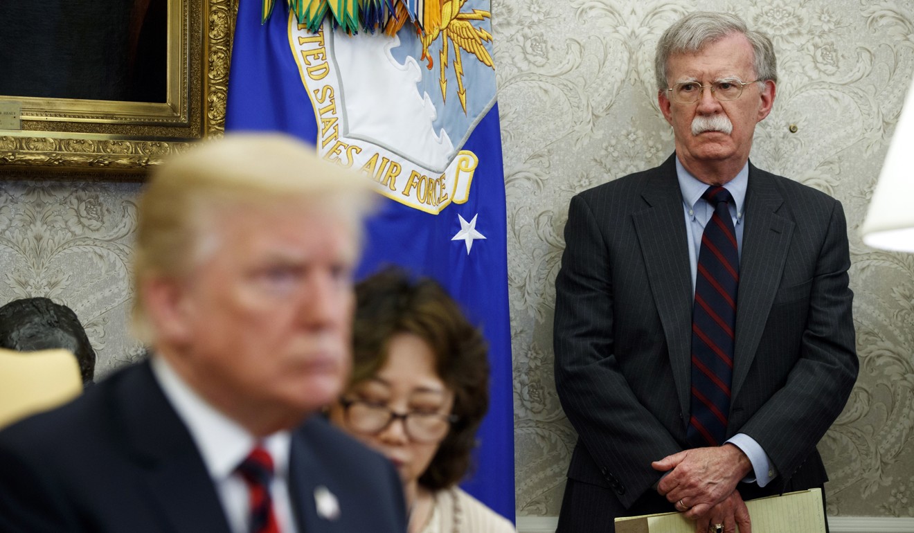 US President Donald Trump (left) at a meeting in the Oval office in May 2018 as national security adviser John Bolton watches. Photo: AP