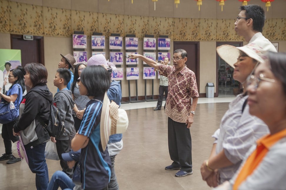 Museum employee Surikin (centre) explaining Hakka history to visitors from Malaysia. Photo: Agoes Rudianto