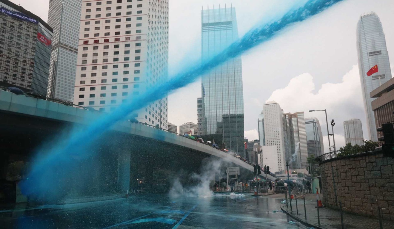 Police fire blue dye from water cannon at the junction of Tim Wa Avenue and Harcourt Road in Admiralty on August 31. Photo: Felix Wong