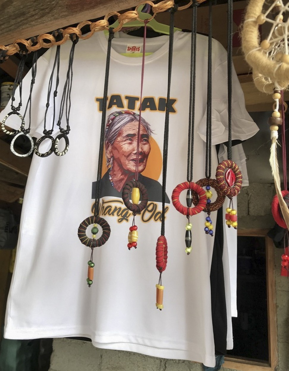 T-shirts emblazoned with the face of the elder tattooist Whang-od for sale in the village. Photo: Ian Gill