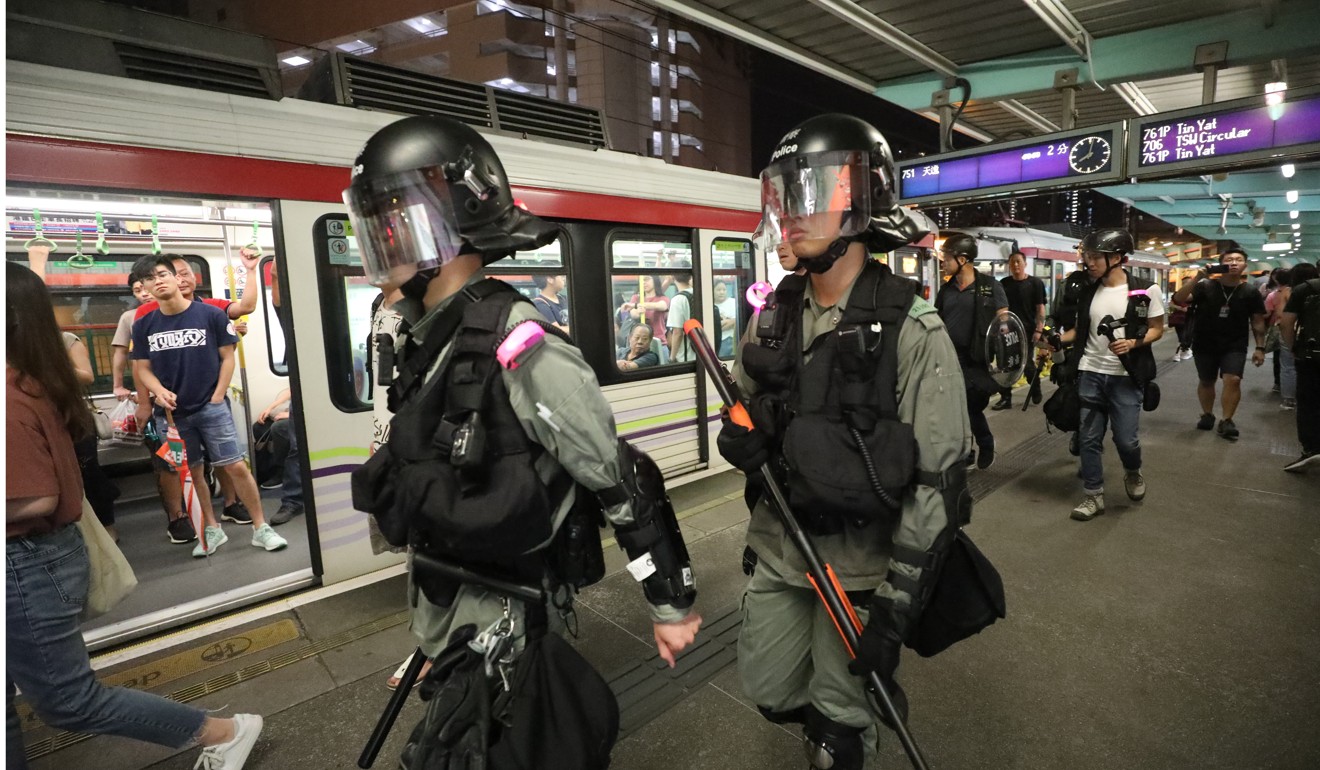 Riot police at a Light Rail stop in Tin Shui Wai. Photo: Dickson Lee