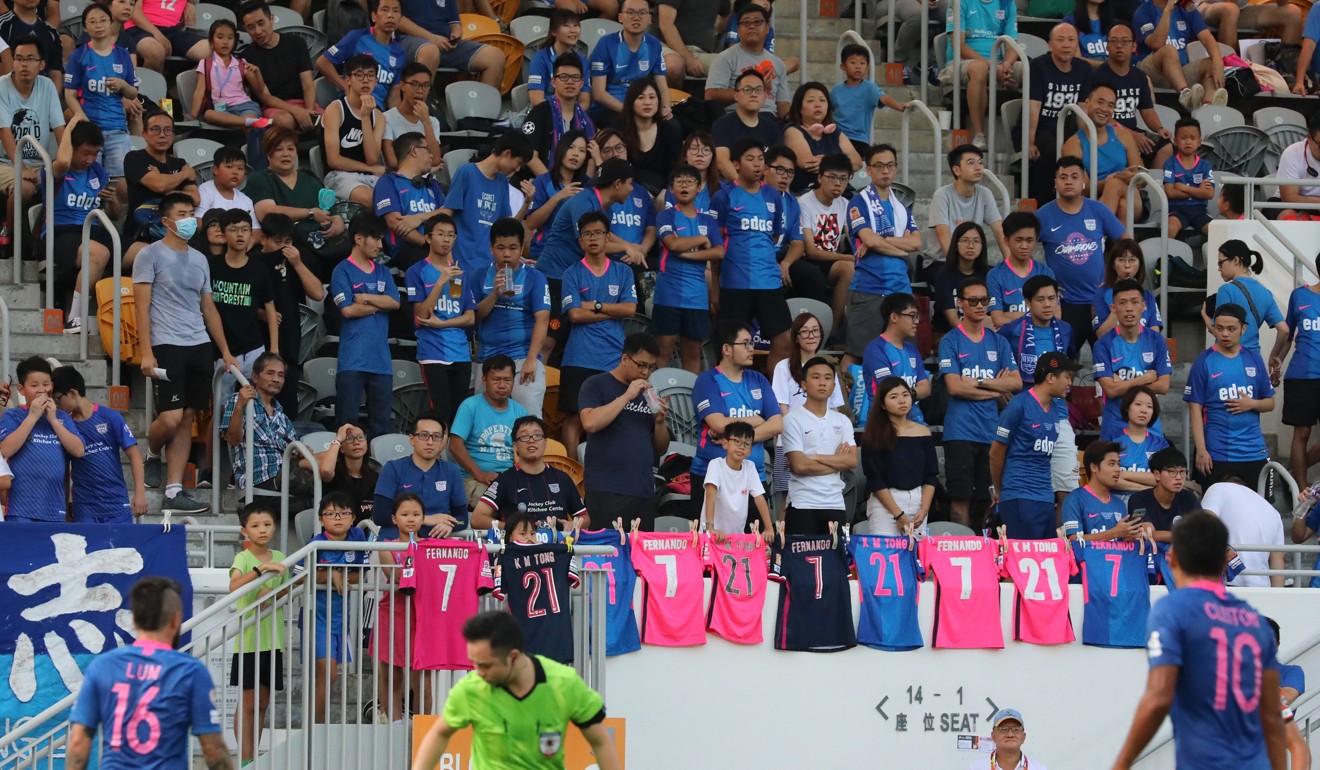 Football fans make a symbolic gesture during Kitchee’s game against Yuen Long in Mong Kok Stadium. Photo: Felix Wong