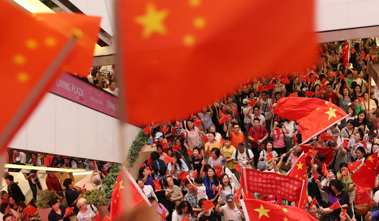 Pro-Beijing supporters wave the Chinese flag during a confrontation in Amoy Plaza. Photo: Sam Tsang