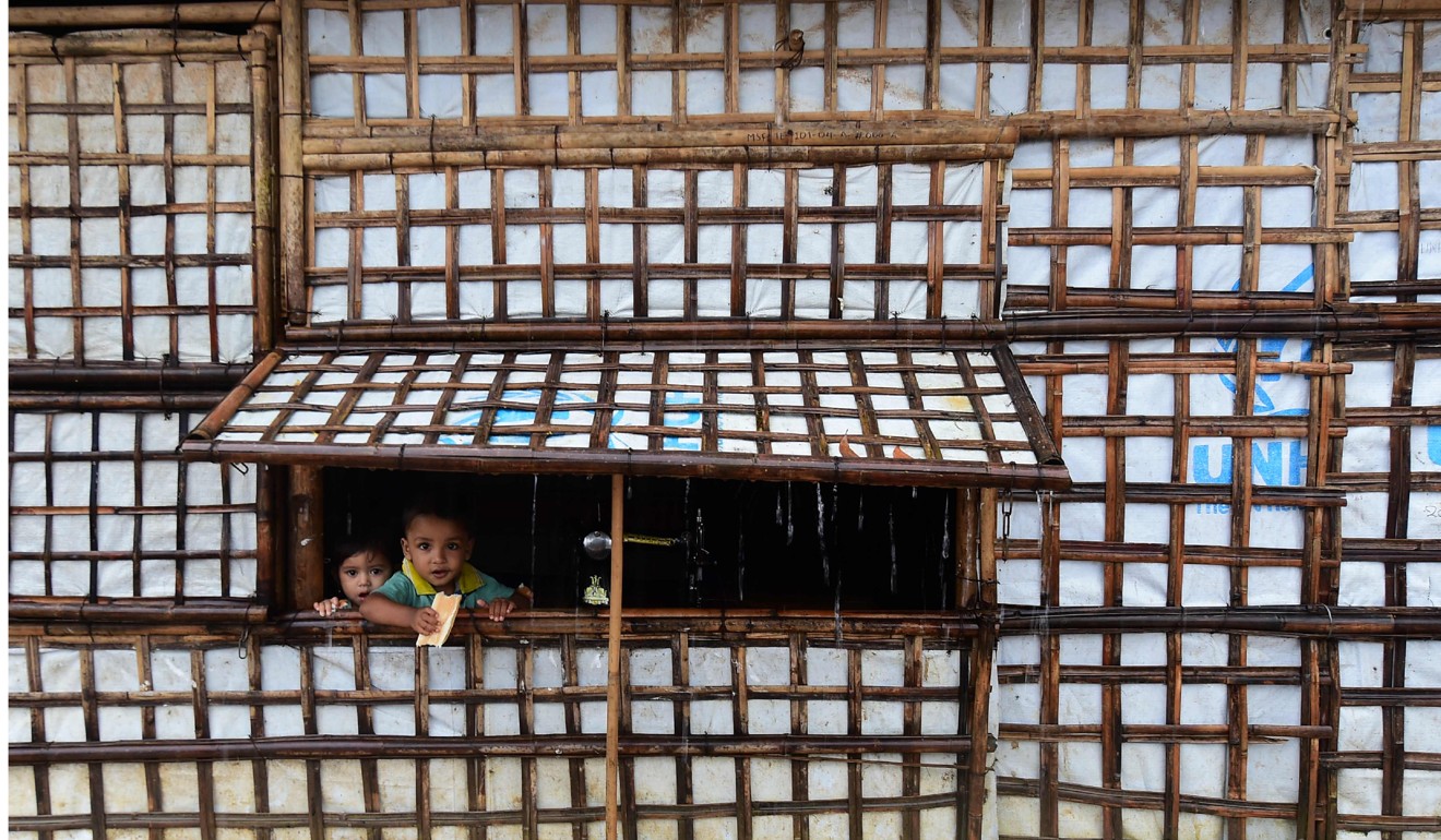 Rohingya refugee children look out of their makeshift house in a refugee camp Bangladesh. Photo: AFP