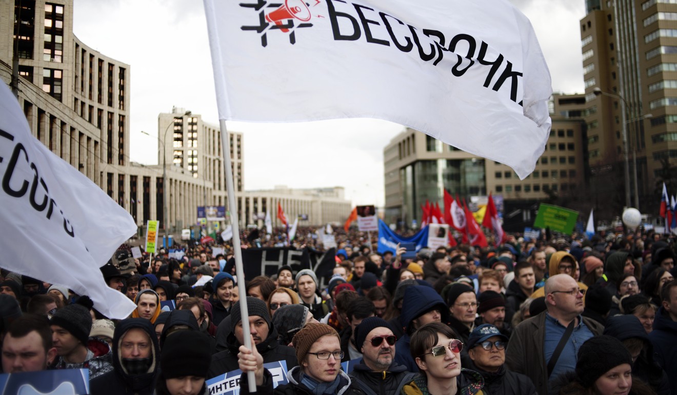 Protesters wave flags during a rally in Moscow. Photo: AP