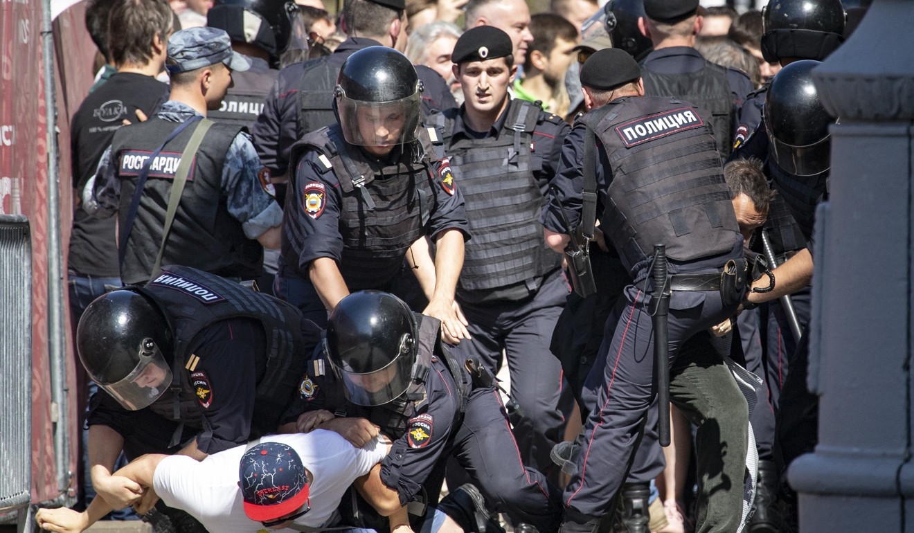 Police officers detain protesters during an unsanctioned rally in Moscow. Photo: AP