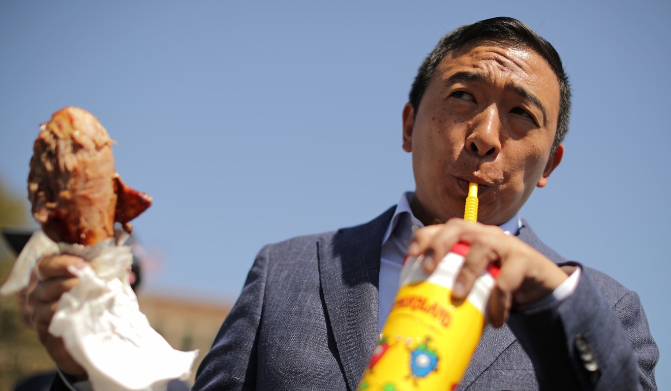 Democratic presidential candidate Andrew Yang eats a roasted turkey leg while visiting the Iowa State Fair in August. Photo: AFP