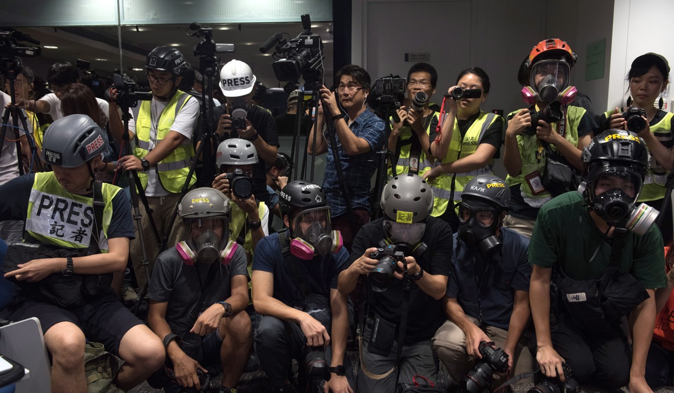 Journalists wear safety equipment at a Hong Kong Police press conference at Police Headquarters on September 9, in protest at what they say is police brutality against their colleagues during demonstrations. Photo: EPA-EFE