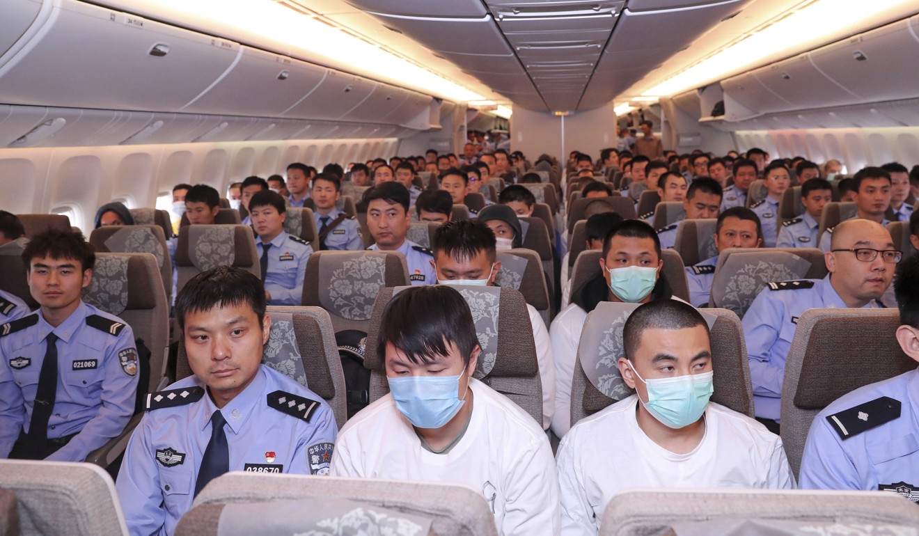 Police and criminal suspects sit on a plane at Beijing Capital International Airport in Beijing, Friday, June, 7, 2019. A group of 94 Taiwanese accused of telephone and online fraud arrived at Beijing airport Friday after being extradited from Spain, Chinese authorities said. Photo: Xinhua via AP
