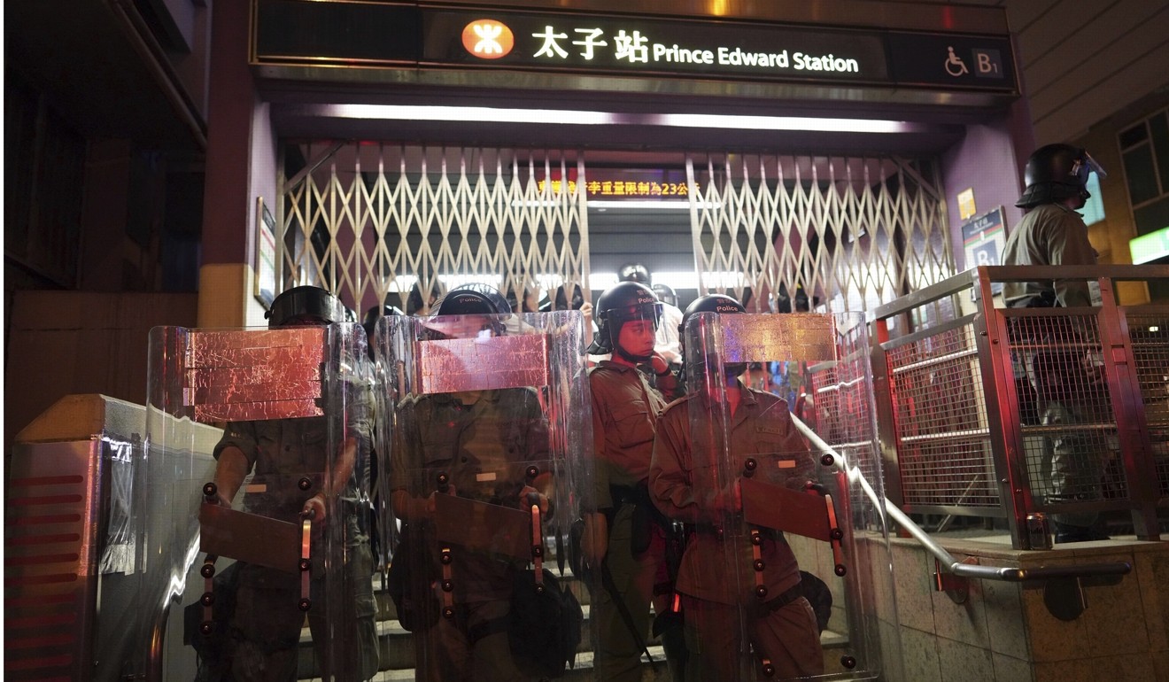 Police stand guard at Prince Edward MTR station on August 31. Photo: AP